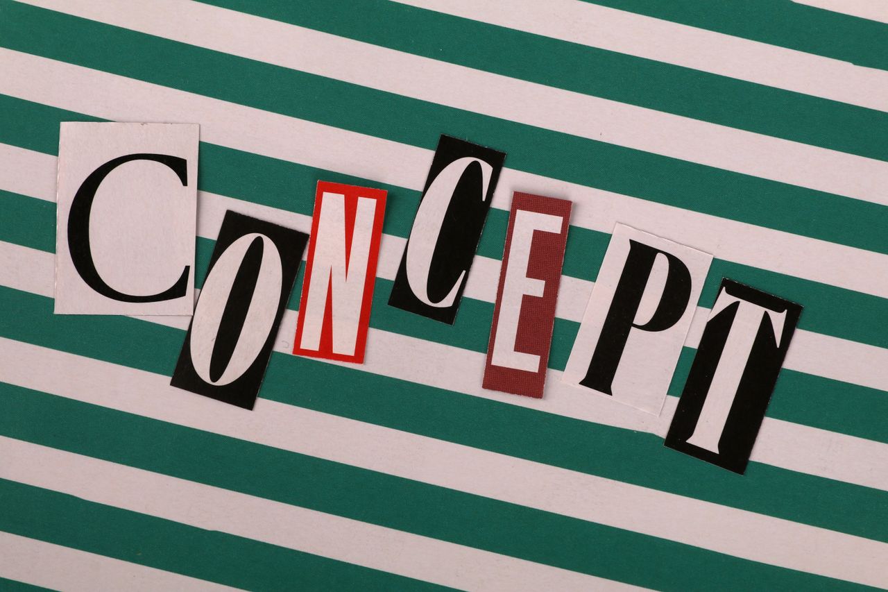 Vintage cut-out letters spelling CONCEPT on a striped background.